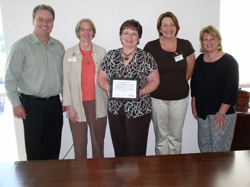 CHESS members present plaque to representatives of Charter Business Services