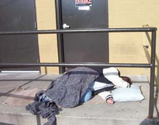 Person Sleeping Near Door to Treatment Center