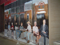 mural on a wall with people sitting at benches